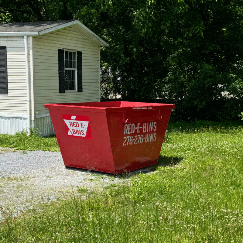 5 yard Red-E-Bins dumpster placed beside a mobile home in Southwest VA for a light residential cleanout project
