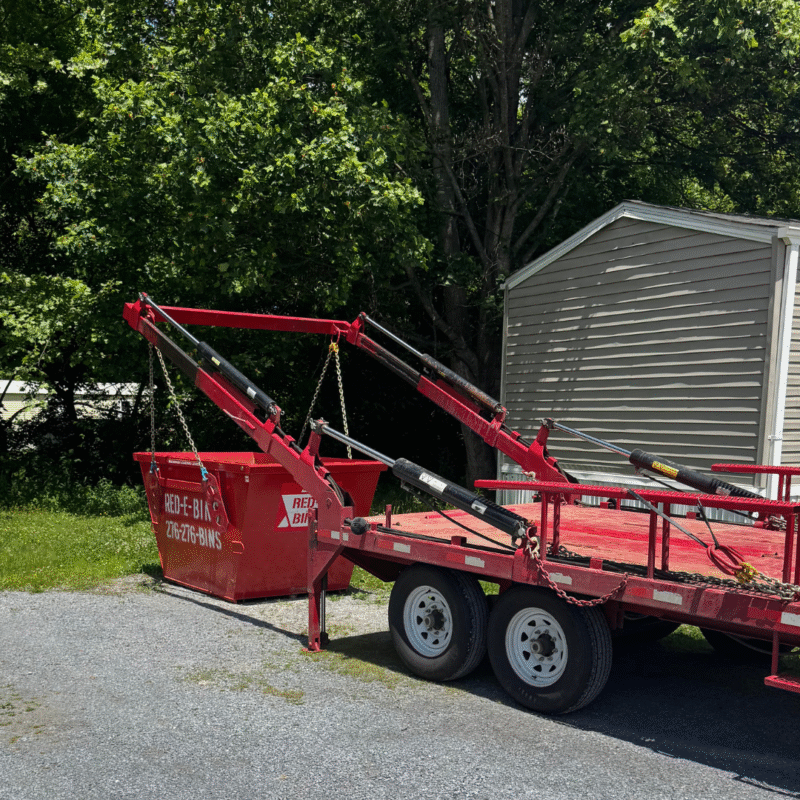 Red-E-Bins 5 yard dumpster being placed beside a home in Southwest VA for a small residential junk removal or yard project