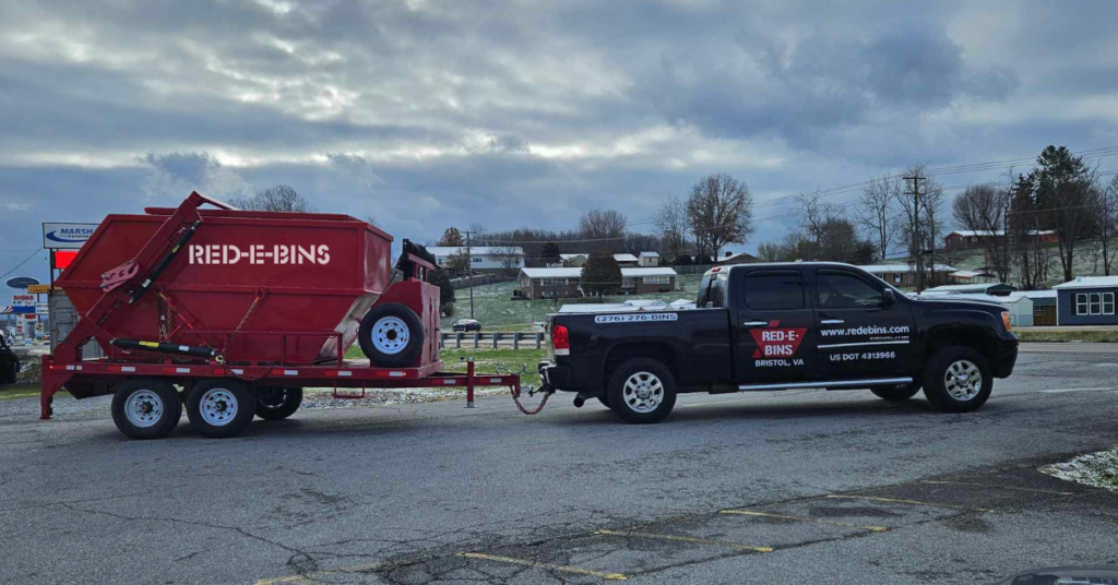 Red-E-Bins truck towing a compact dumpster in Bristol, VA, showcasing driveway-friendly and residential dumpster rental services.
